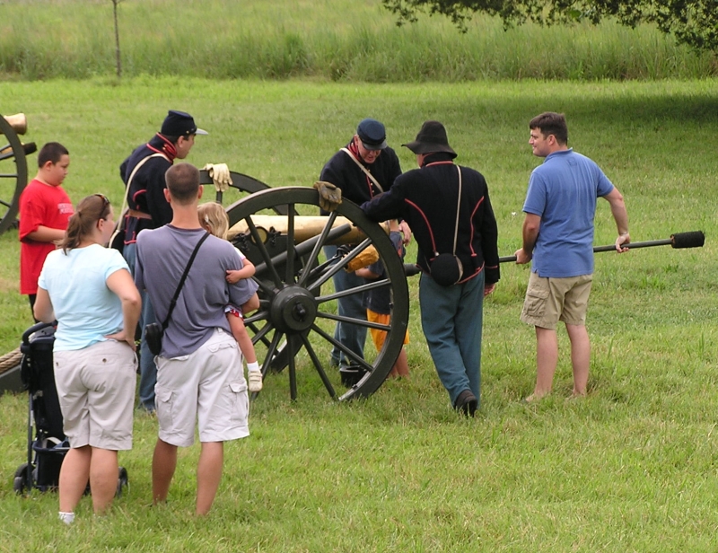Civil War reenactors preparing to fire a cannon
