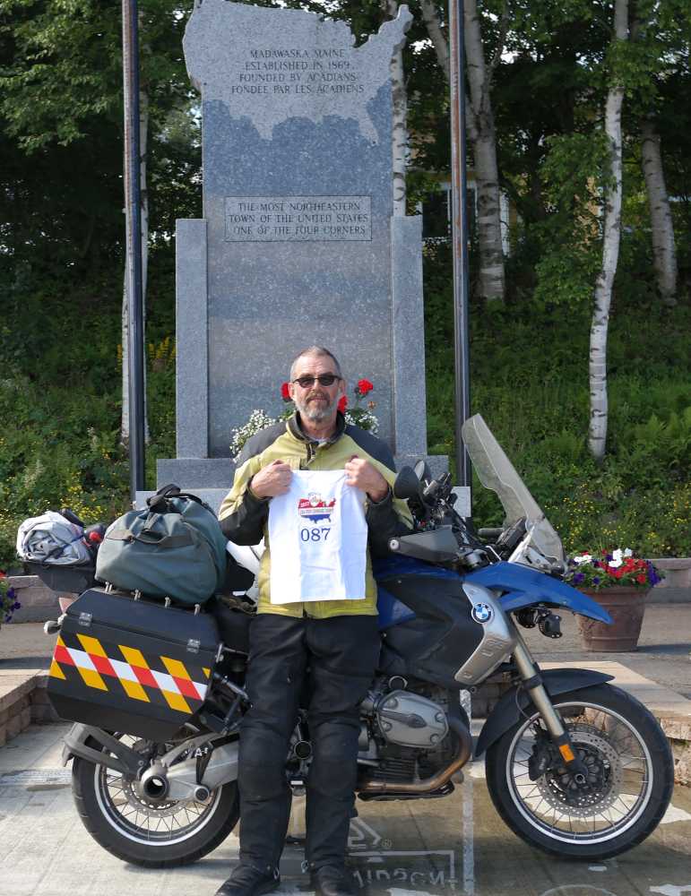 Fulton and the bike at the Four Corners Monument in Madawaska